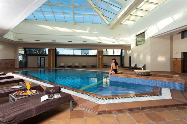 Indoor pool, open 9:00 AM to 7:00 PM, pool loungers