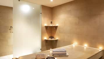 A modern bathroom with a large countertop, a mirror, and a wall-mounted sink.