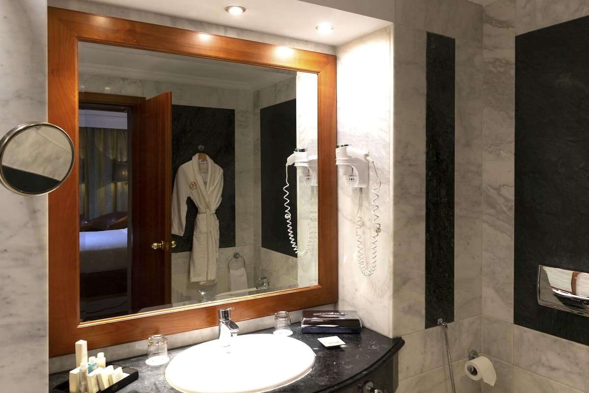 bathtub, designer toiletries, hair dryer, bathrobes