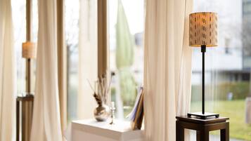 A room with a table and a lamp.