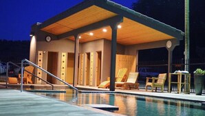 A covered pool area with lounge chairs and a wooden deck. - Hampton Inn Twin Falls Id (Twin Falls)