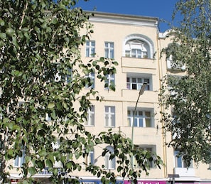 A multi-story building with a central arched window and multiple windows on each floor. - Hotel Abendstern (Berlin)