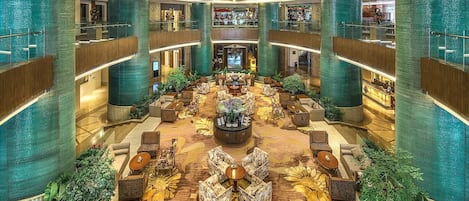 A spacious lobby with a central seating area, multiple levels, and a modern design.