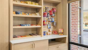 A snack display with various packaged foods and a window view.