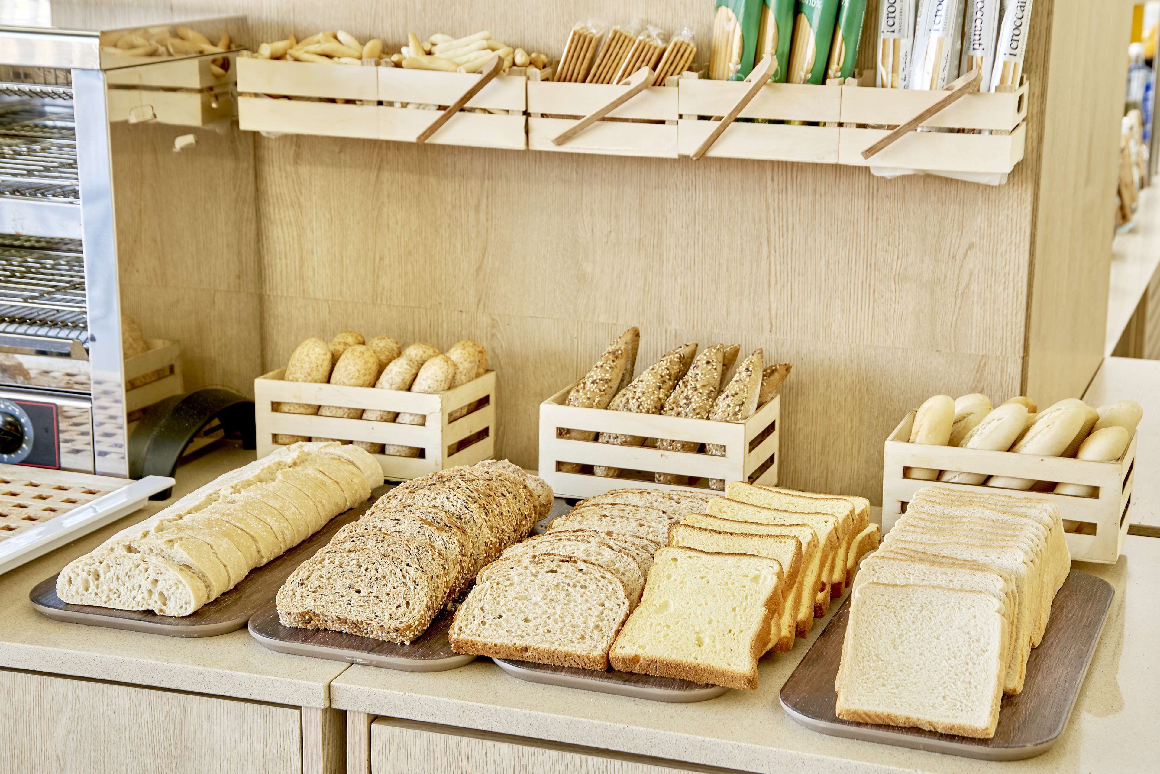 A bakery display with various breads and pastries.