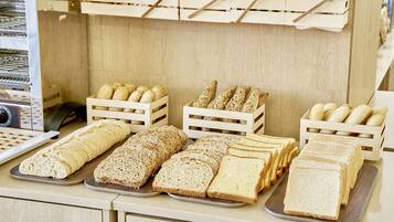 A bakery display with various breads and pastries.