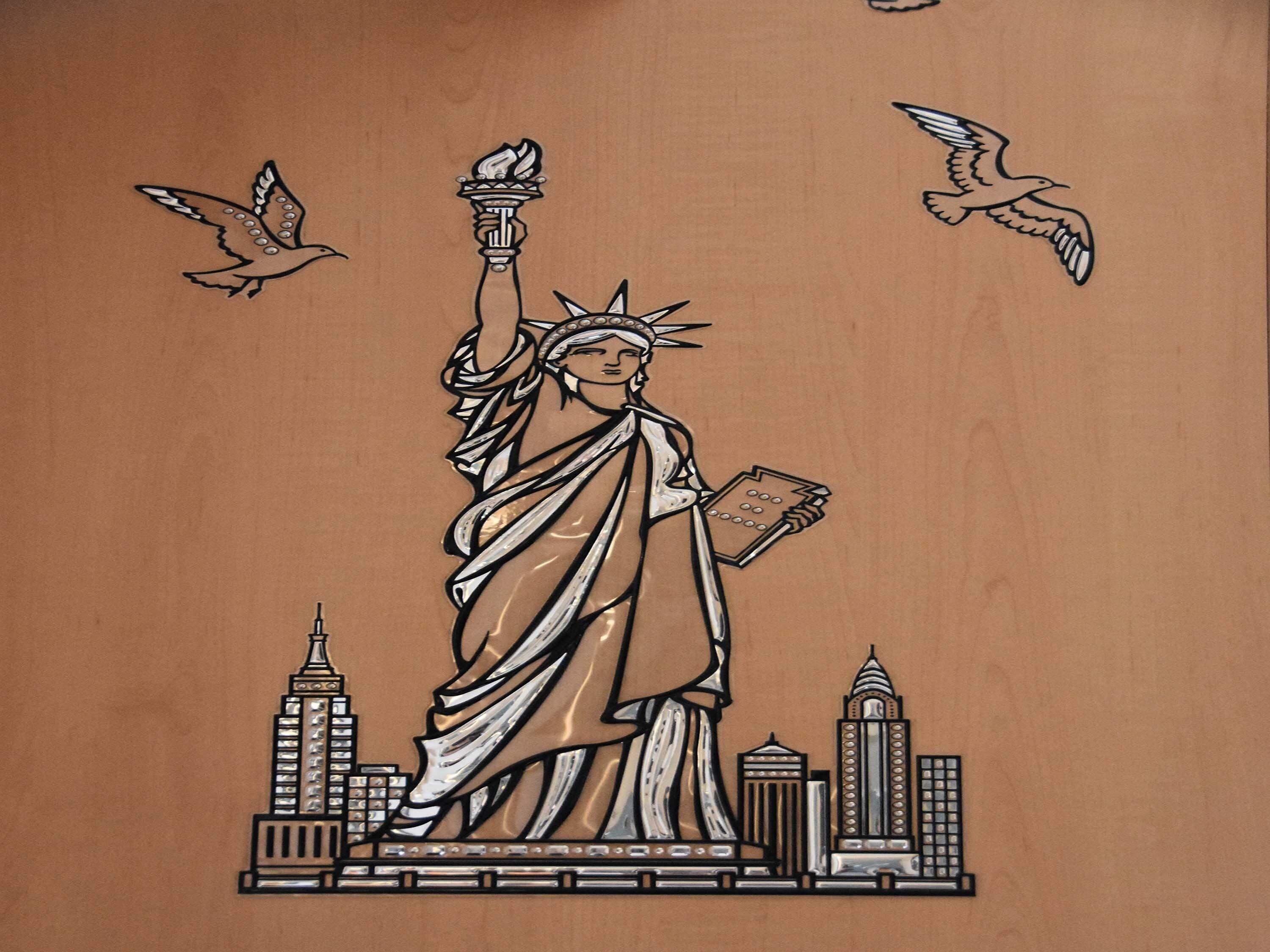 A stylized depiction of the Statue of Liberty with birds flying around it and a cityscape at the base.
