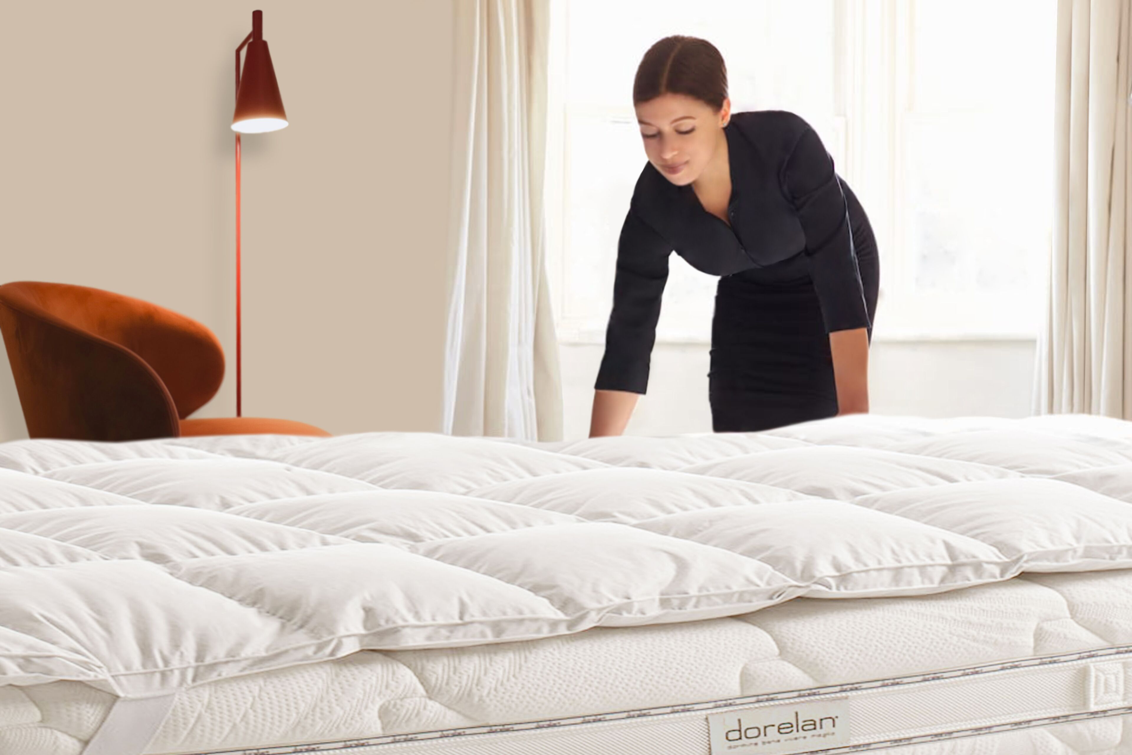 A bed with a white mattress and a label reading "dorelans".