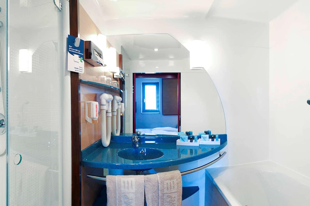 separate bathtub and shower, eco-friendly toiletries, hair dryer, towels