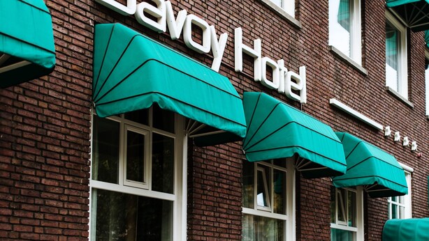 A brick building with the sign "Savoy Hotel" and green awnings over the windows. - Savoy Hotel Amsterdam (Amsterdam)