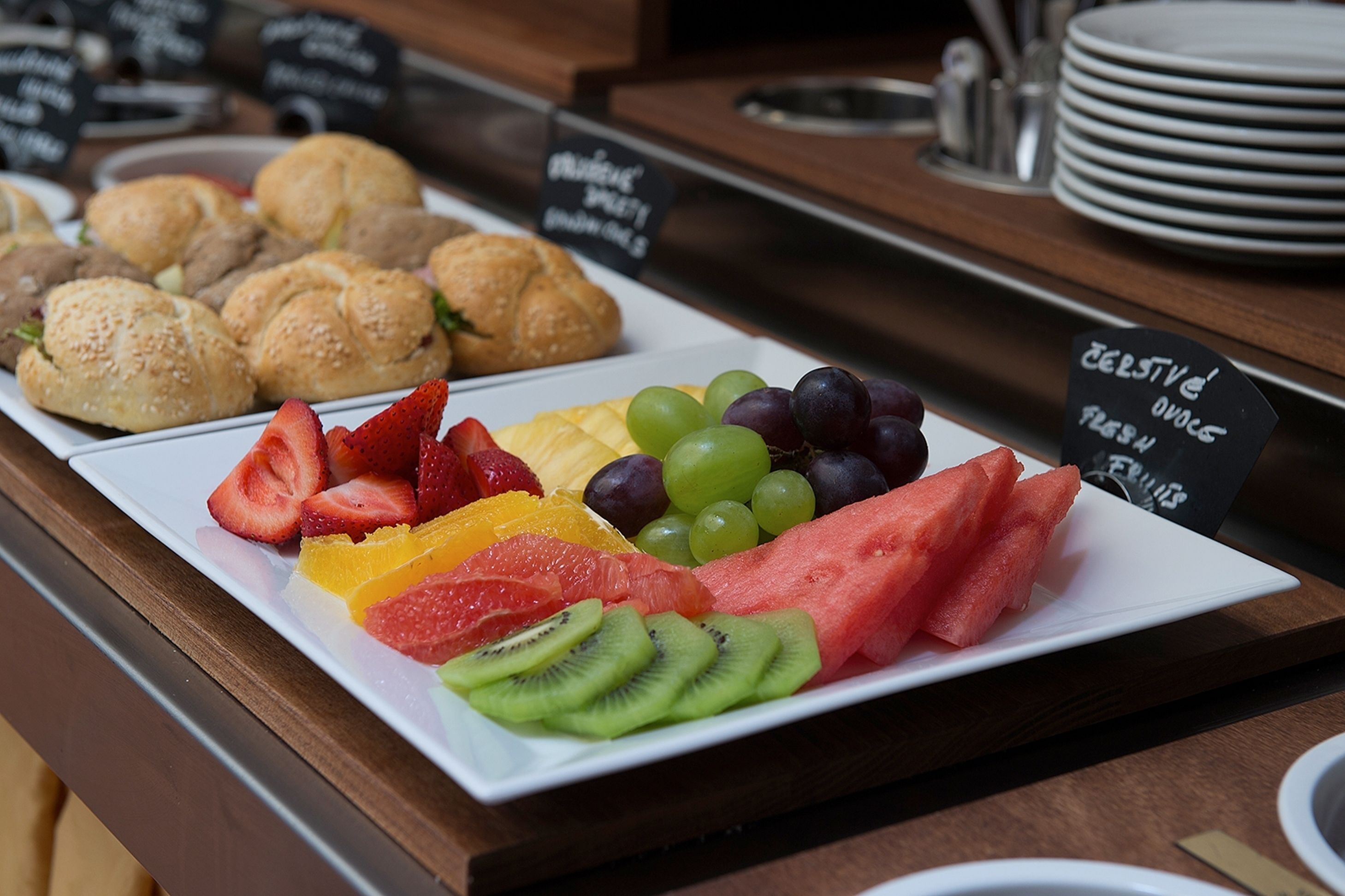 A breakfast buffet with various pastries and fresh fruit.