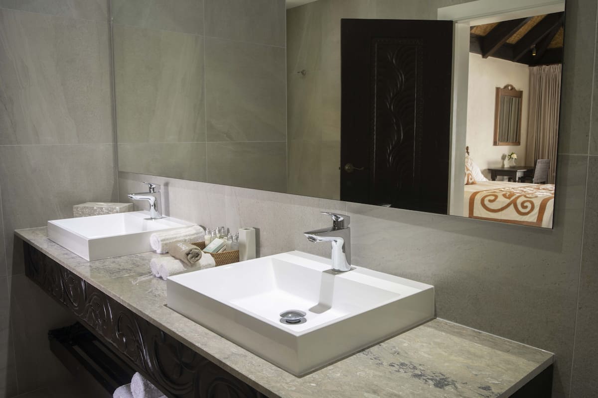 premium beachfront suite | bathroom | shower, free toiletries, hair dryer, towels