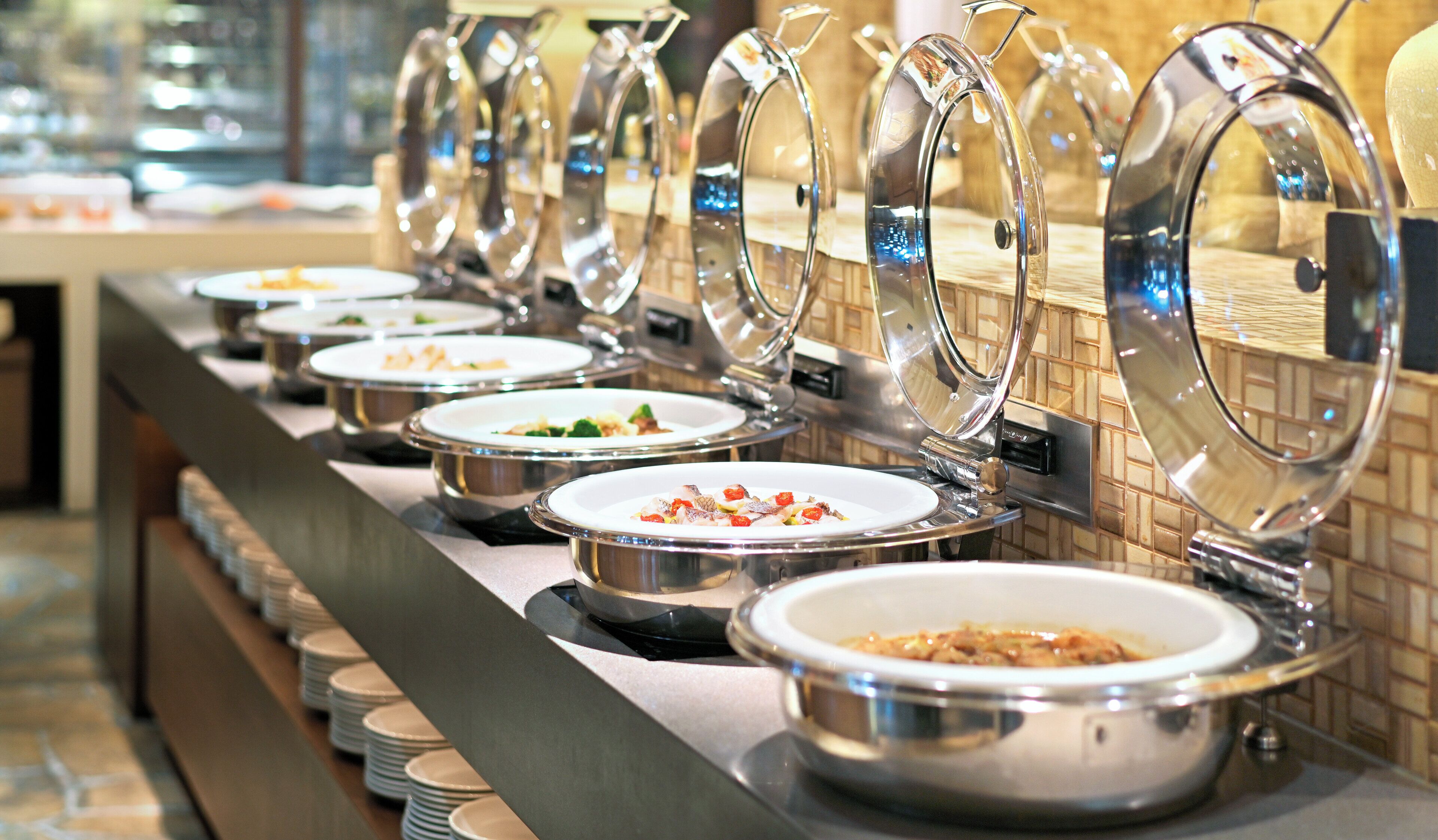 A buffet line with covered food stations.