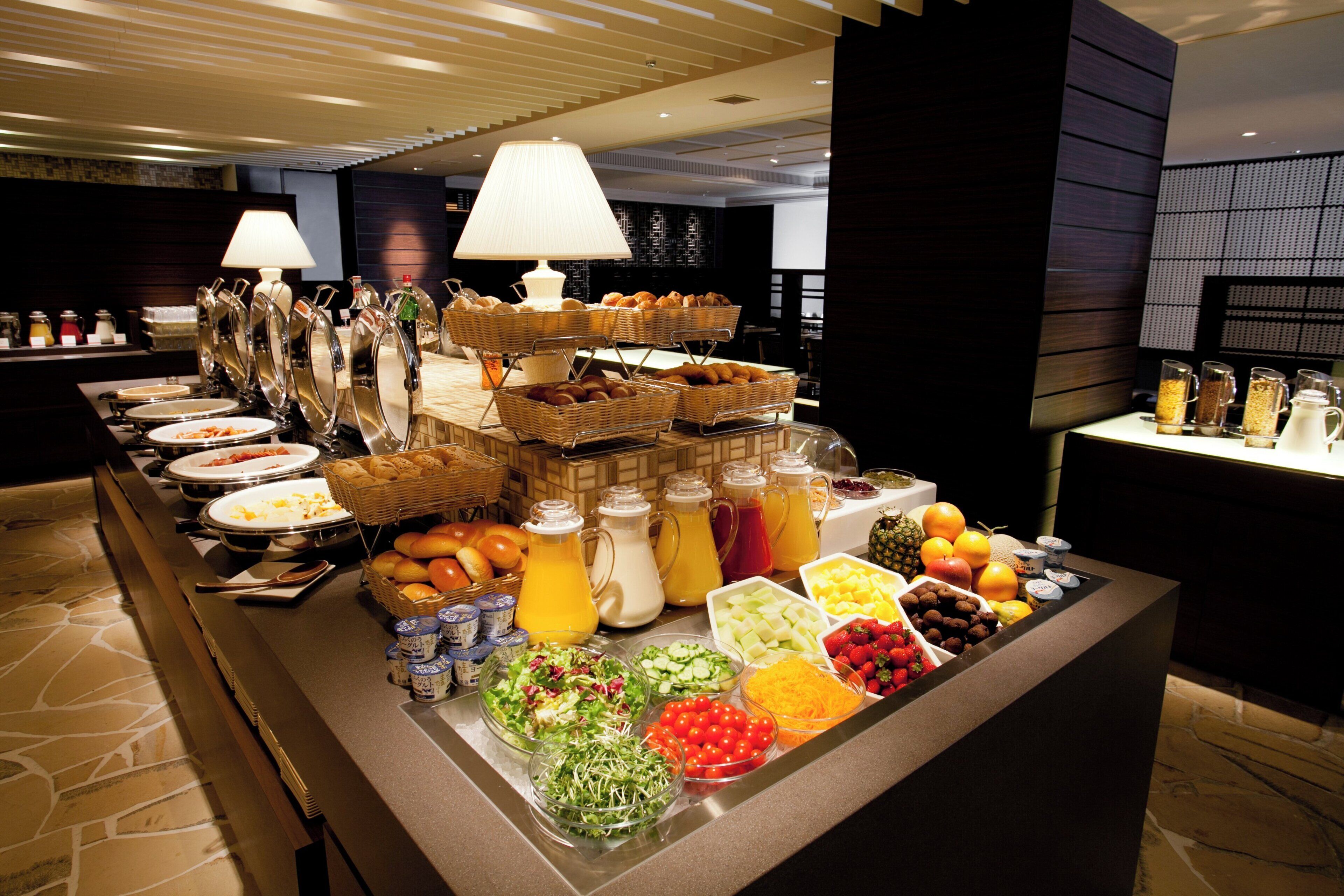 A buffet with various food items and beverages.