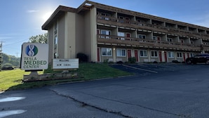 A multi-story building with a sign indicating it is a Tesla Medbed Center.