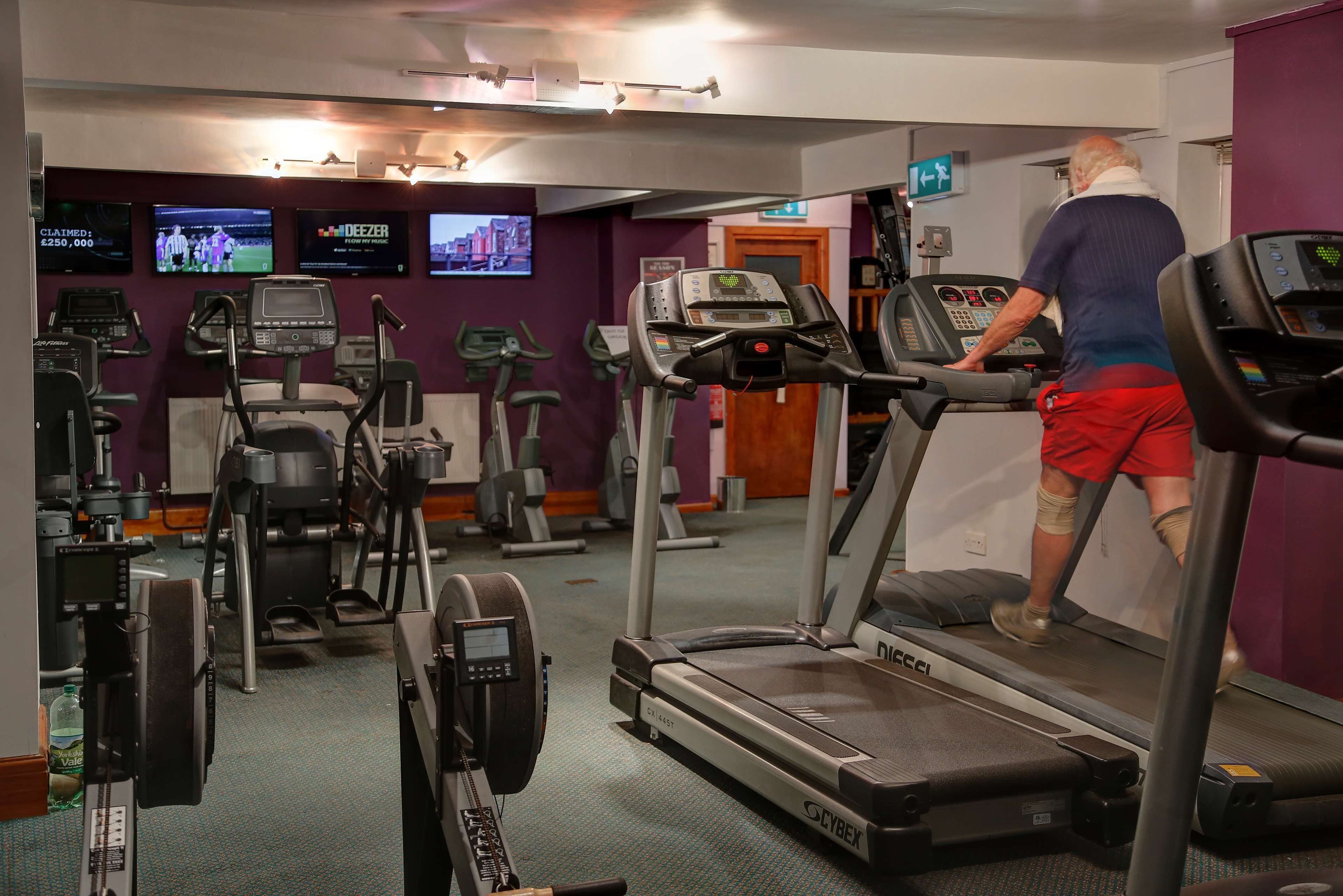 A gym with treadmills, ellipticals, and weight machines.
