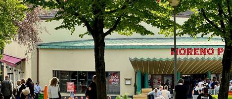 A street scene with a building labeled 'MORENO PIZZA' and a pedestrian walkway.