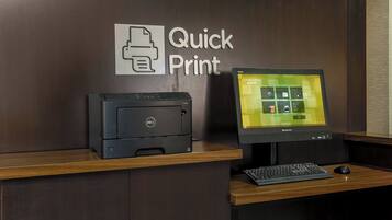 A desk with a Dell printer, a Lenovo monitor, and a keyboard.
