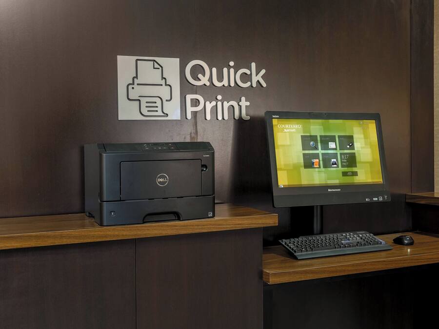 A desk with a Dell printer, a Lenovo monitor, and a keyboard.