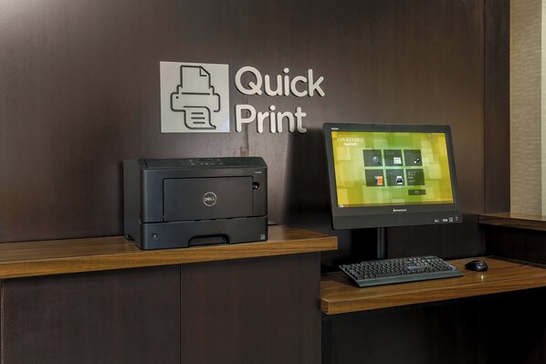 A desk with a Dell printer, a Lenovo monitor, and a keyboard.