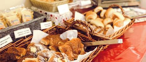 A variety of baked goods displayed in baskets on a table.