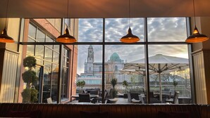 A restaurant with large windows offering views of a historic building with a clock tower and dome. - Radisson Blu Hotel, Athlone (Athlone)
