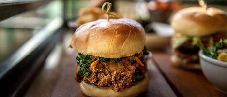 A sandwich on a wooden table with a blurred background.