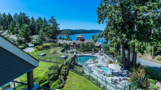 A residential property with a swimming pool, a gazebo, and a view of a lake. - Poets Cove Resort & Spa (Pender Island)