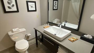 Bathtub, designer toiletries, hair dryer, towels