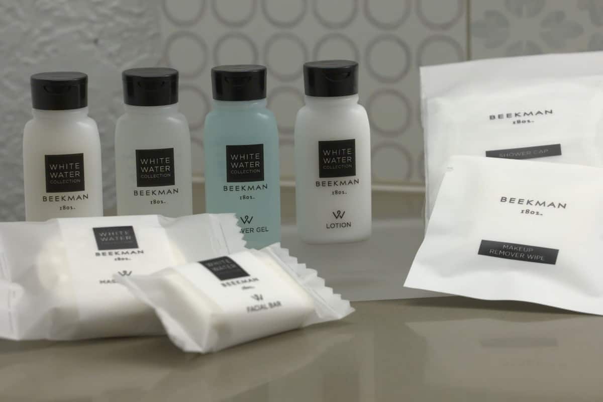 bathtub, designer toiletries, hair dryer, towels