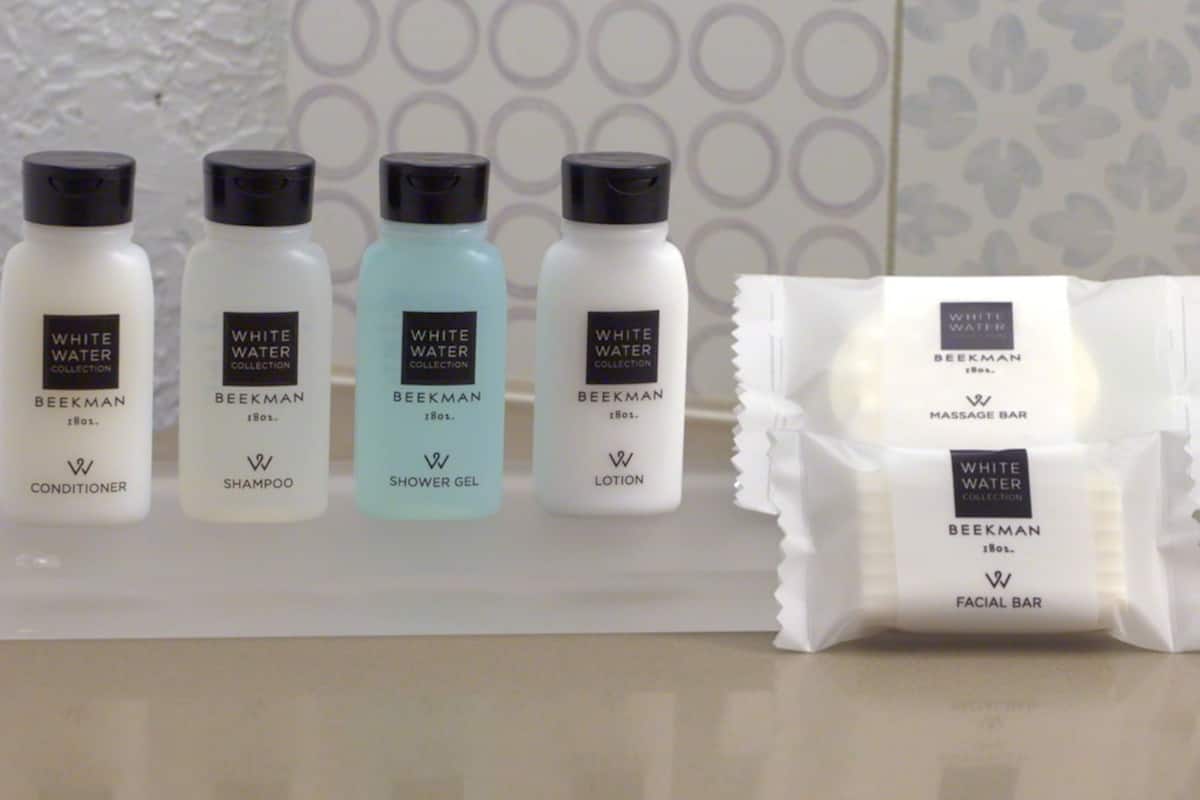 bathtub, designer toiletries, hair dryer, towels