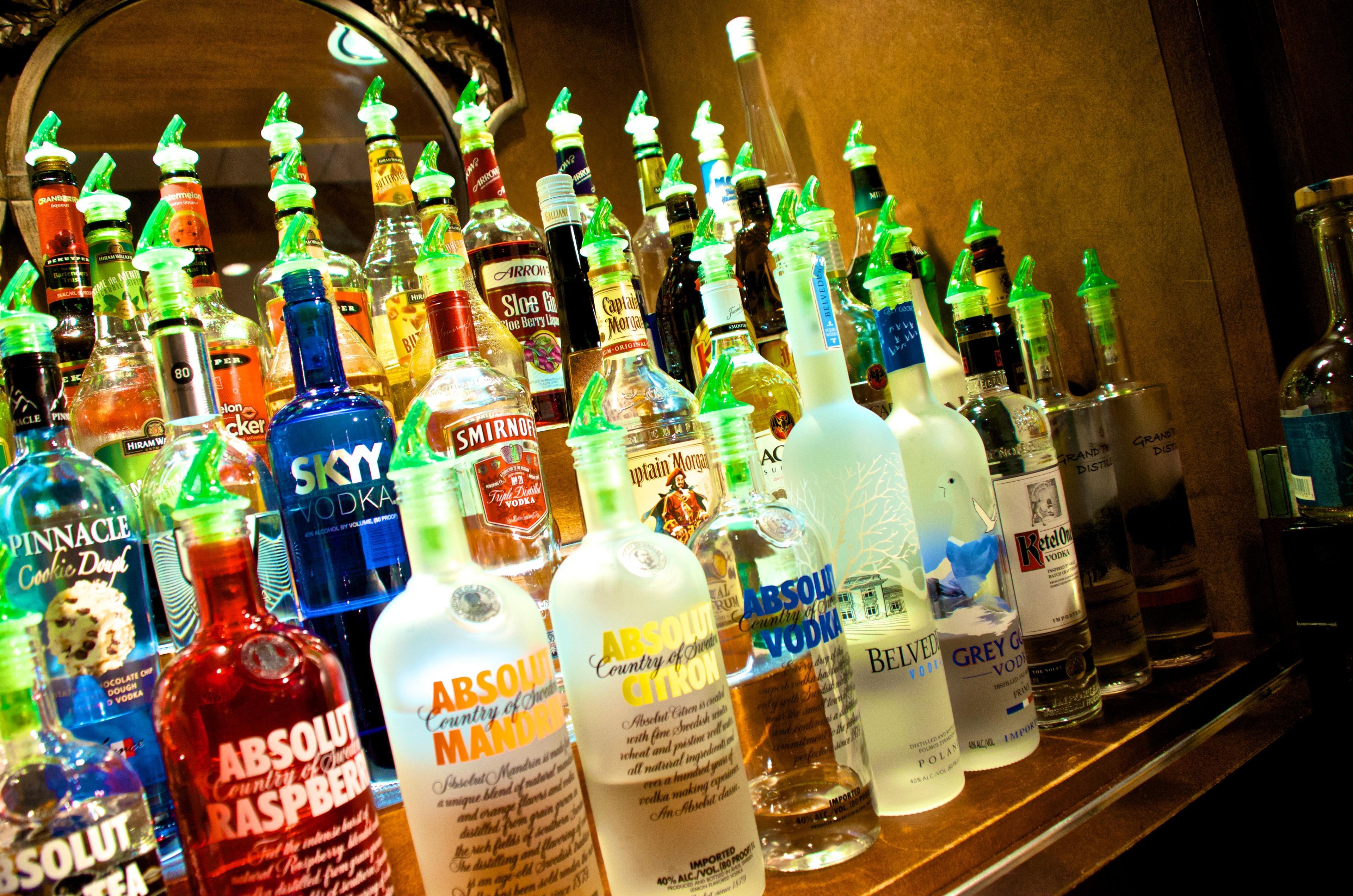 A variety of liquor bottles displayed on a shelf.