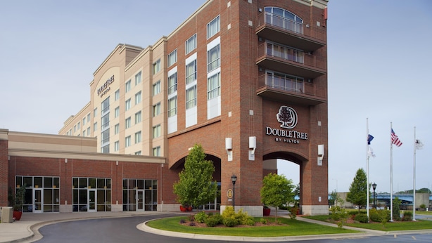 A hotel with a brick facade, multiple windows, and a prominent entrance archway.