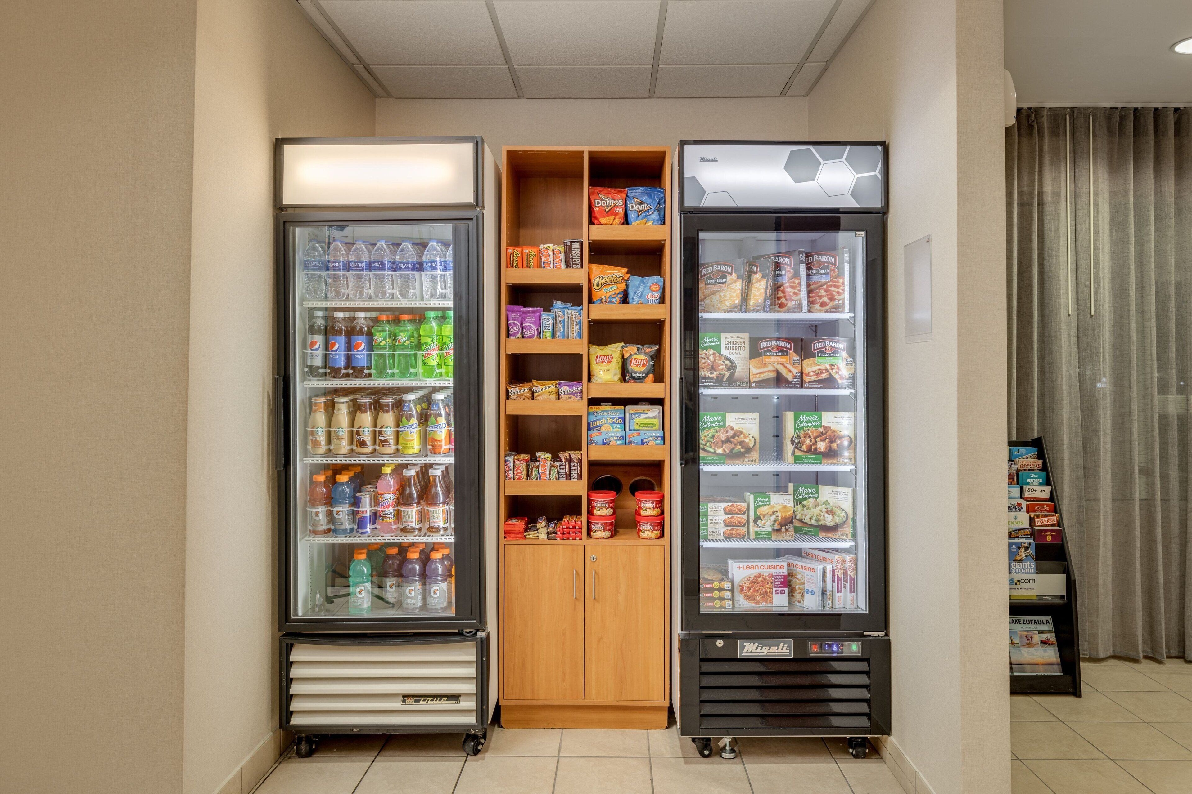 A vending area with refrigerated beverage dispensers and snack shelves.