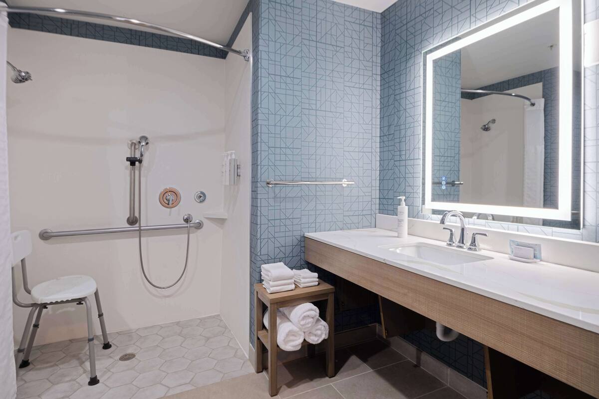 studio, 1 king bed, accessible (mobility & hearing, roll-in shower) | bathroom | combined shower/bathtub, free toiletries, hair dryer, towels