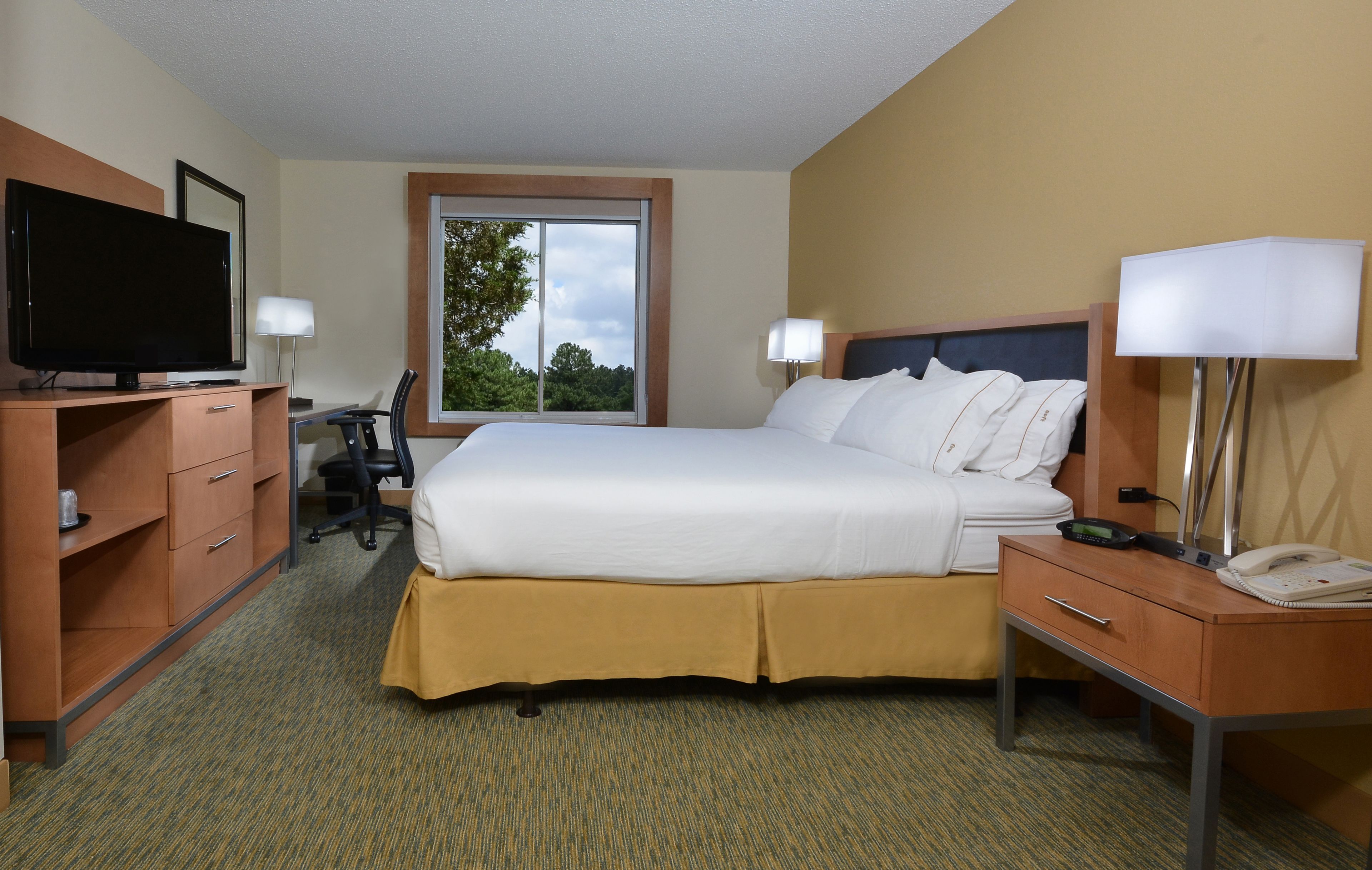 Premium bedding, desk, laptop workspace, blackout drapes
