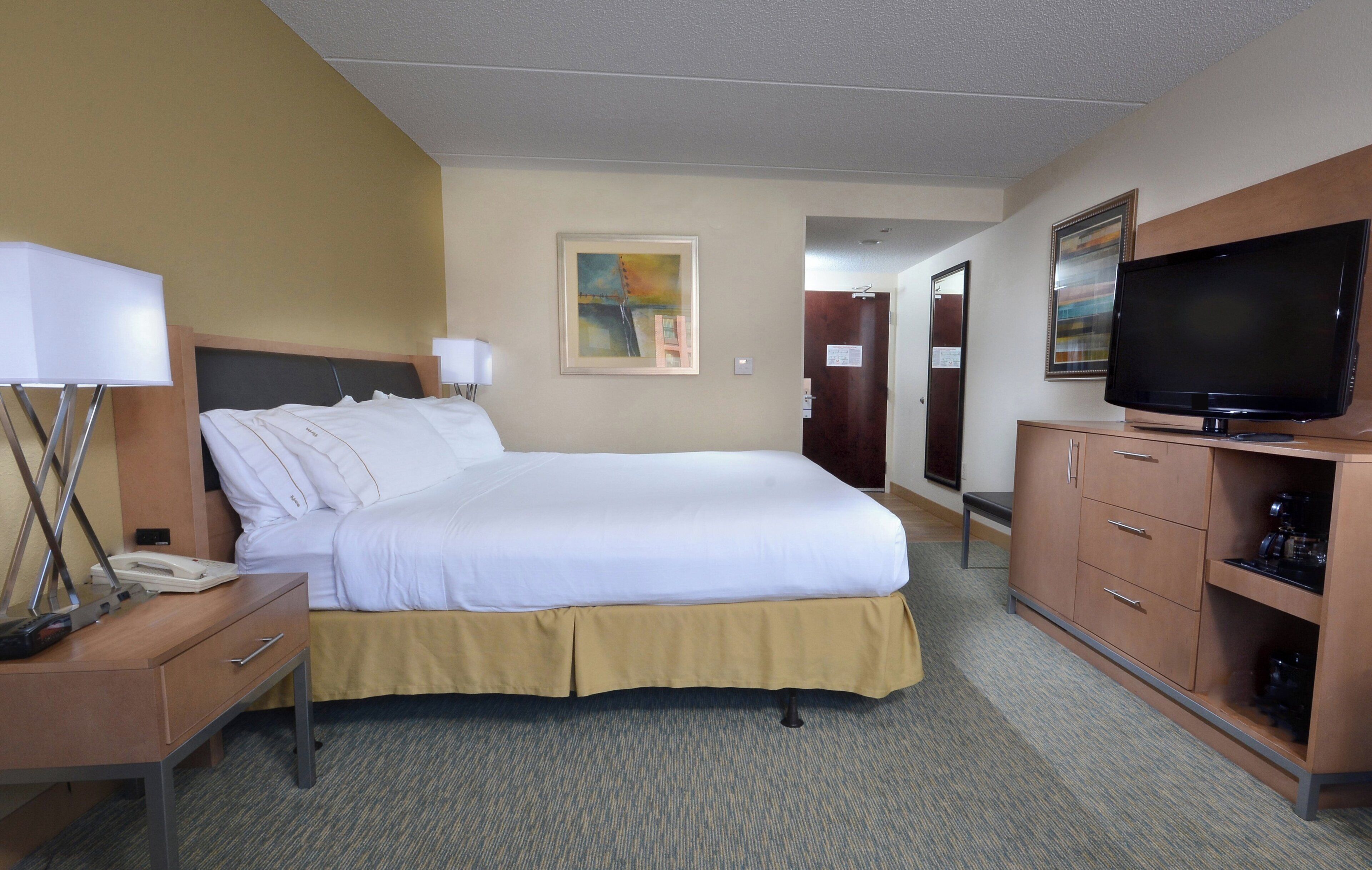 Premium bedding, desk, laptop workspace, blackout drapes