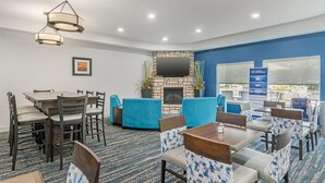 A hotel room with a dining area, a fireplace, and a view of the outdoors. - Best Western Plus Washington Hotel (Washington)