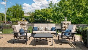 An outdoor patio with a beige sofa set, two armchairs, and a table. - Best Western Plus Washington Hotel (Washington)
