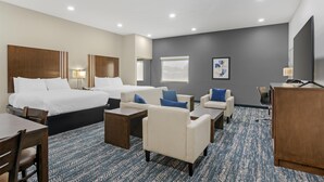 A hotel room with a large bed, two sofas, a desk, and a TV. - Best Western Plus Washington Hotel (Washington)