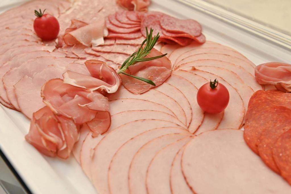 A variety of sliced meats arranged on a platter.