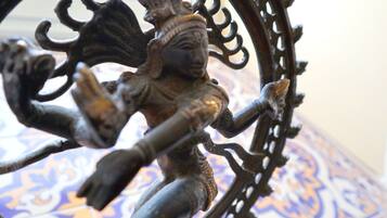 A close-up of a decorative metalwork with intricate designs and a figure.
