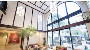 A spacious lobby with high ceilings, large windows, and a variety of seating arrangements including sofas and chairs. - Hotel Rose Garden Shinjuku (Tokyo)