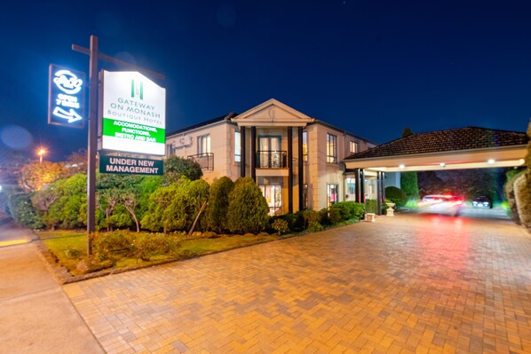 A hotel entrance with a sign indicating "Gateway on Monash Boutique Hotel" and "Under New Management". - Gateway on Monash Boutique Hotel (Notting Hill)