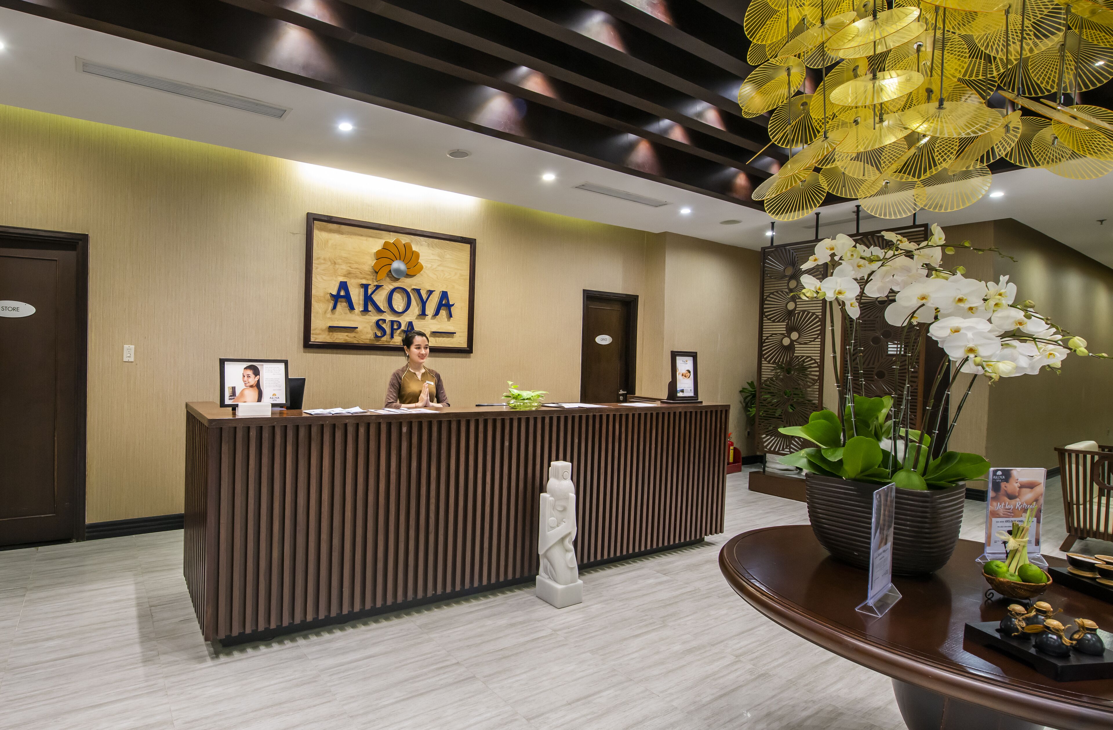 A reception desk with a sign reading "AKOYA SPA".