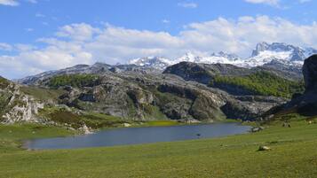A mountainous landscape with a lake and a clear sky.