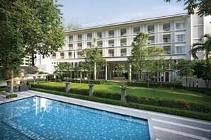 A modern hotel with a swimming pool, lush greenery, and a multi-story building with balconies. - Lone Pine, Penang, a Tribute Portfolio Resort (George Town)