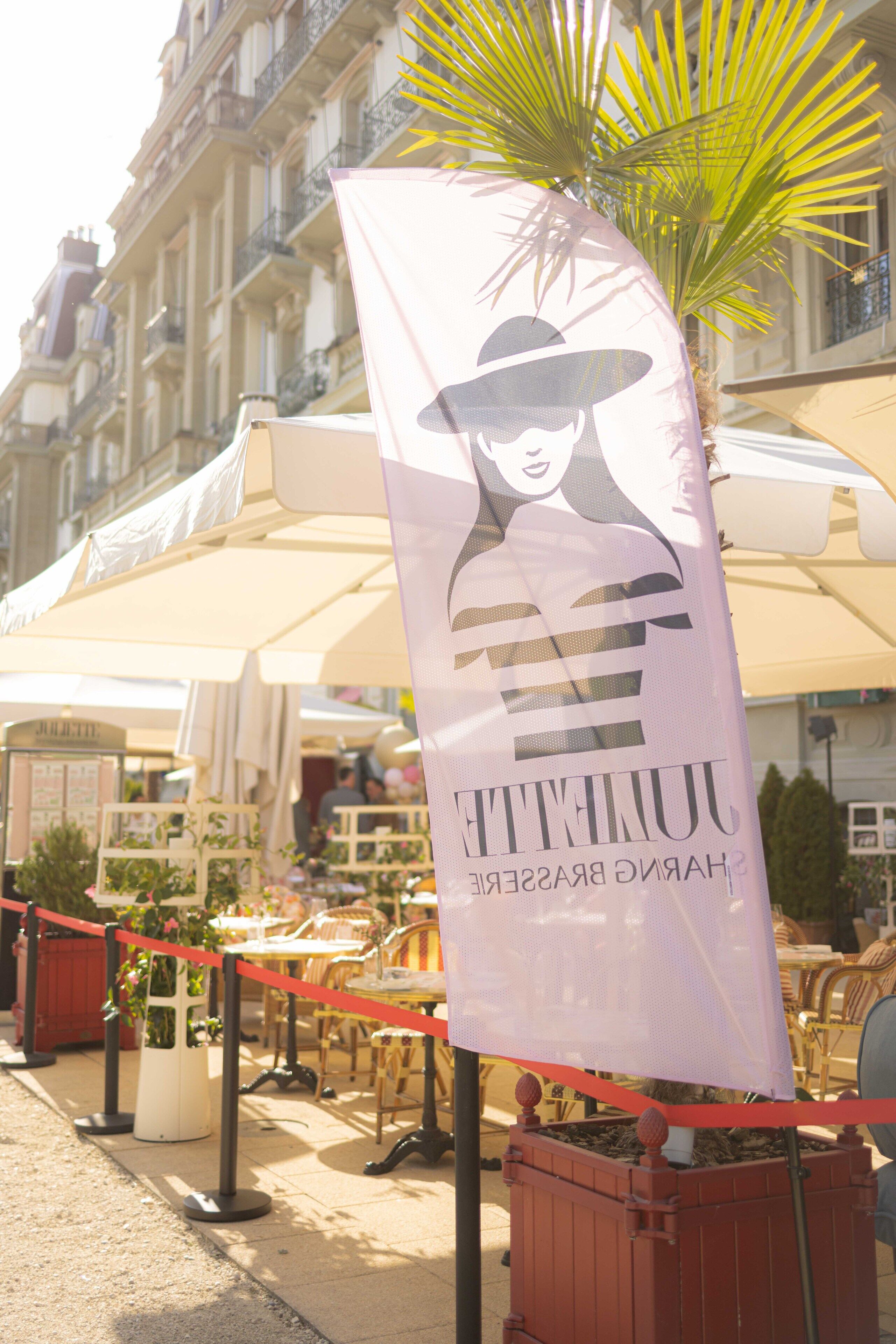 A banner with a woman's silhouette and the text "COUTURE BRASSERIE" in a cafe setting with outdoor seating and a palm tree.