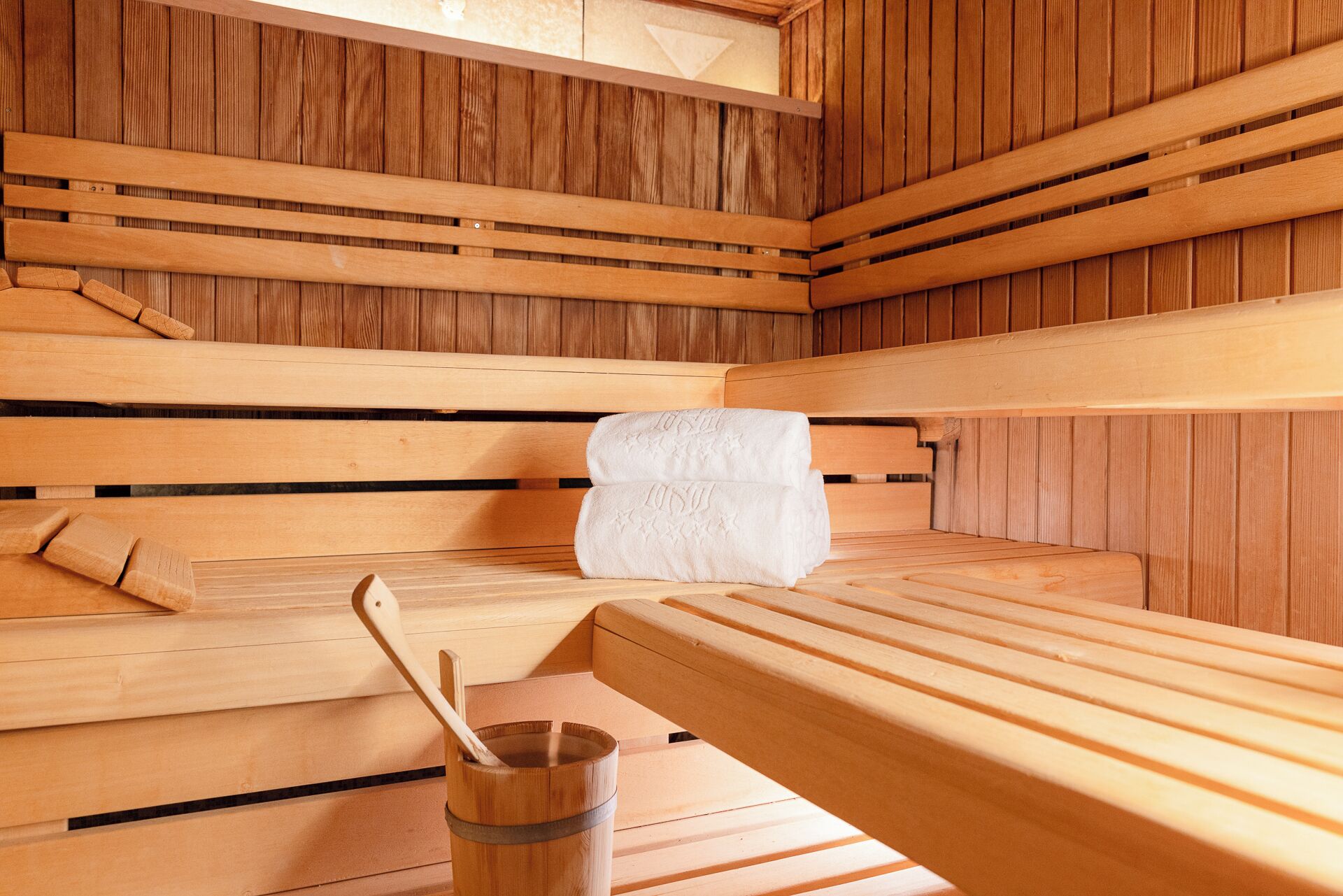 A sauna with wooden benches and a towel on one of the benches.