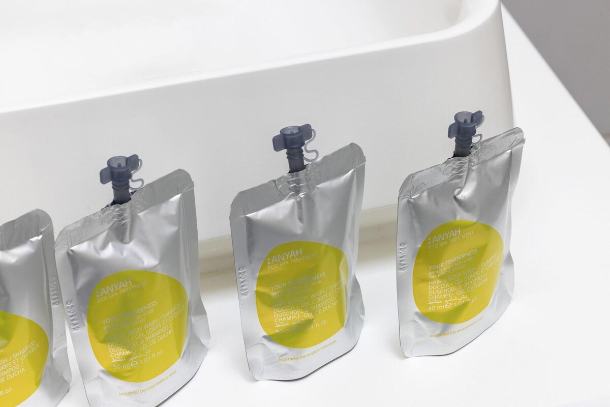 Four transparent plastic bags with yellow labels, each containing a product.